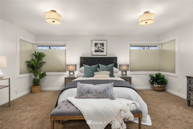 a bed room with a bed and a potted plant