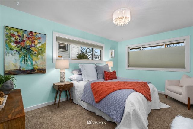 a bedroom with a bed and a painting on the wall