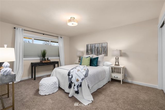 a bedroom with bed and window