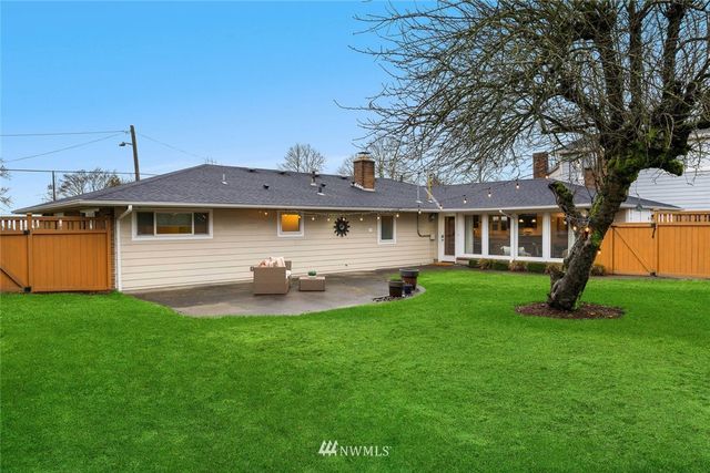 a view of a house with a backyard and a patio