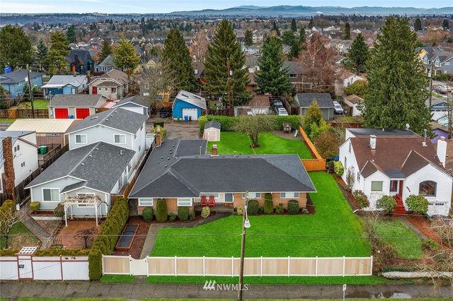 an aerial view of a house with a garden and houses