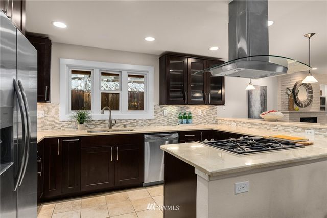 a kitchen with lots of counter top space and stainless steel appliances