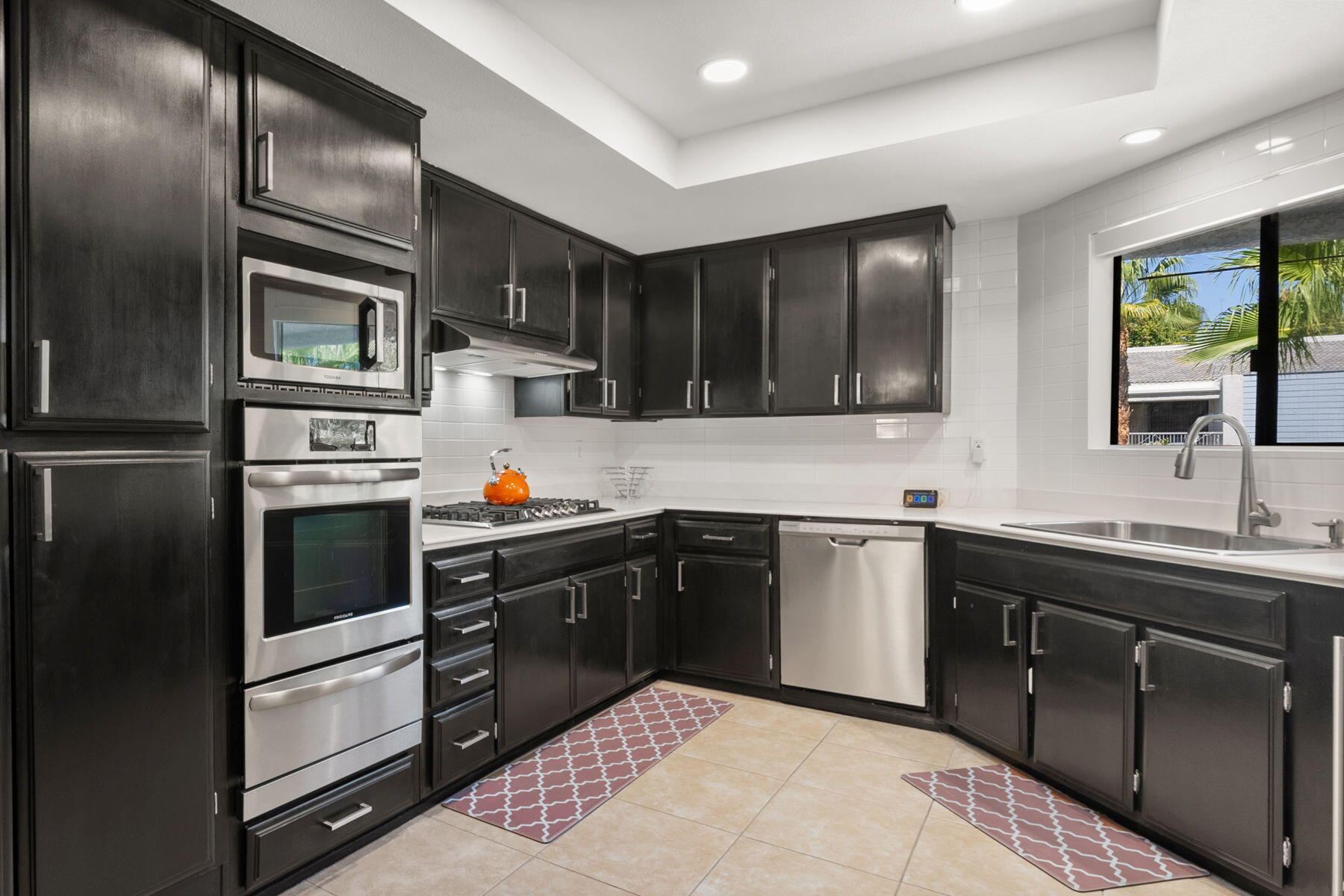 3155 Ramon Road, Unit 808 Palm Springs, CA 92264 - Photo 10 of 37 a kitchen with stainless steel appliances kitchen island granite countertop a refrigerator stove and sink