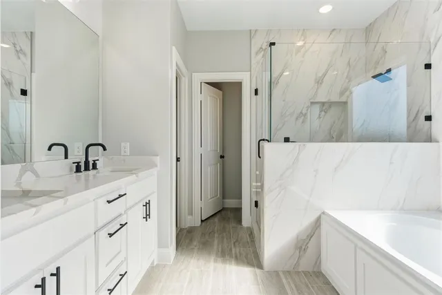 a bathroom with a sink a mirror and shower