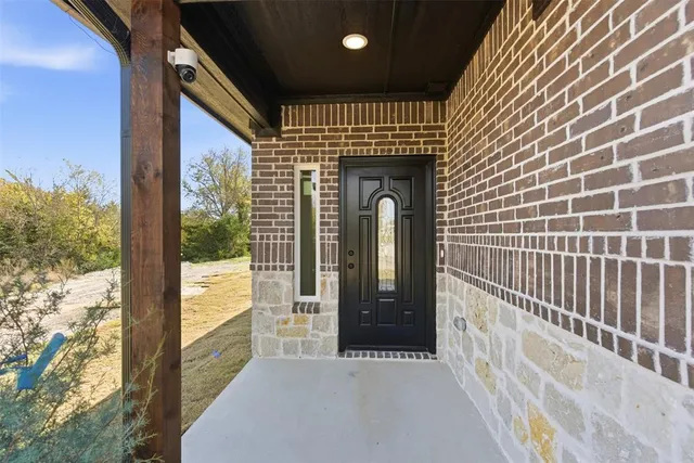an empty room with wooden floor closet and front door