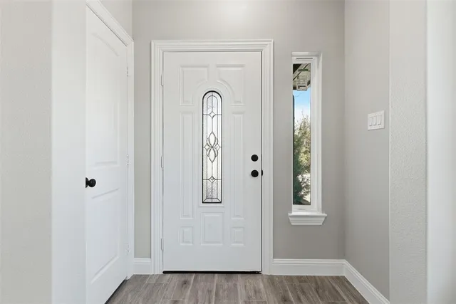 a view of an empty room with a fireplace and a window