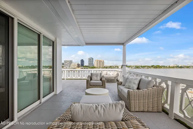 a balcony with furniture and a floor to ceiling window