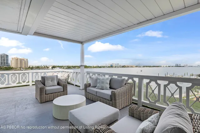 a balcony with furniture and city view