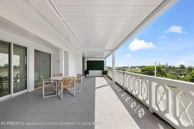 a view of a patio with a table and chairs