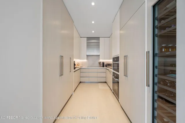 a view of a hallway with a couch and chandelier