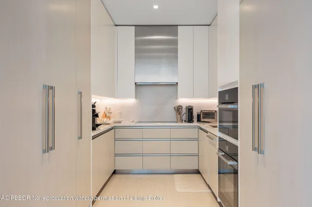 a kitchen with stainless steel appliances a sink and cabinets