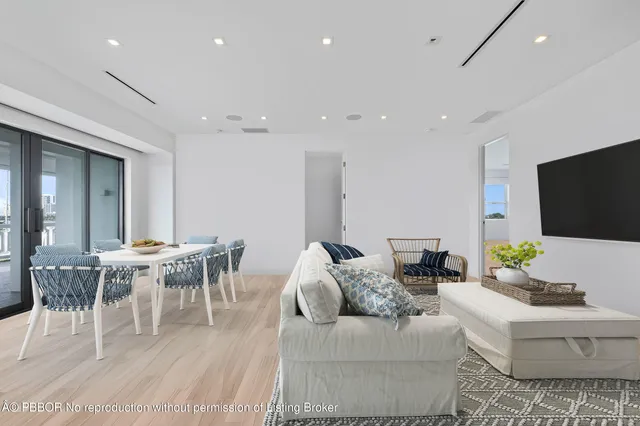a living room with furniture a rug and a flat screen tv