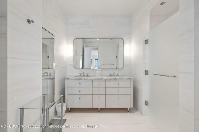 a bathroom with a sink mirror and a shower