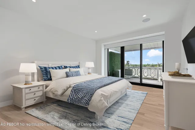 a bedroom with a large bed and a large window