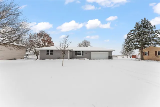a front view of a house with a tree