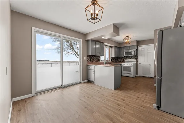 a kitchen with refrigerator cabinets and wooden floor