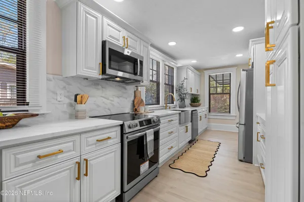 a spacious bedroom with a bed and a chandelier