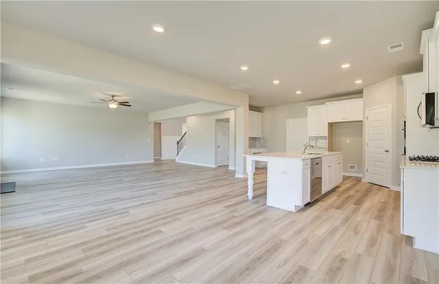 a view of kitchen with wooden floor and electronic appliances