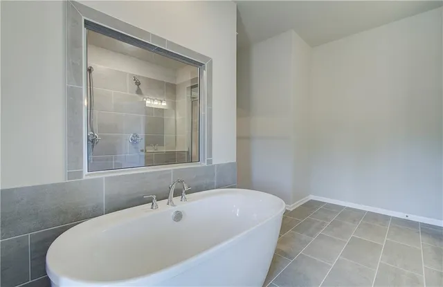 a bathroom with a bathtub and shower