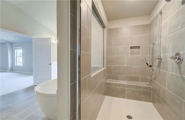 a bathroom with a bathtub and shower
