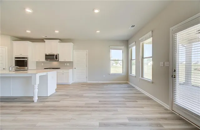 a view of kitchen with sink microwave and refrigerator