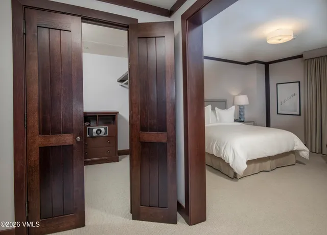 a bedroom with a bed and a mirror