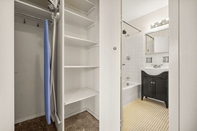a en suite bathroom with a sink shower and a mirror