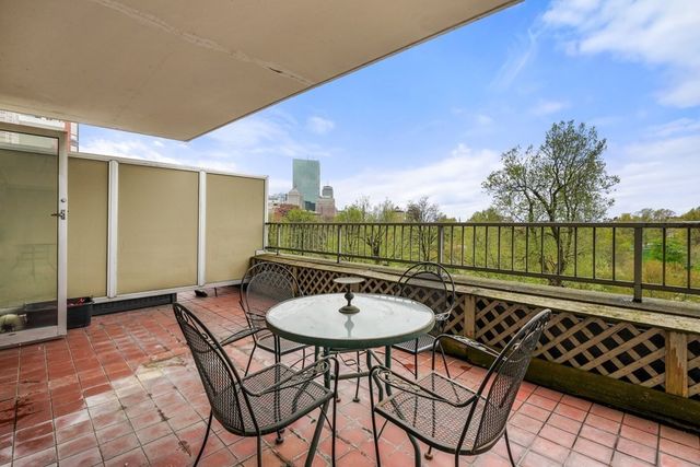 a balcony with table and chairs