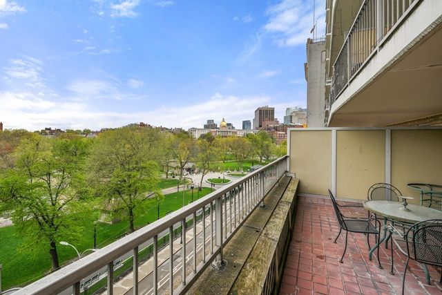 a view of a balcony with mountain view and wooden floor