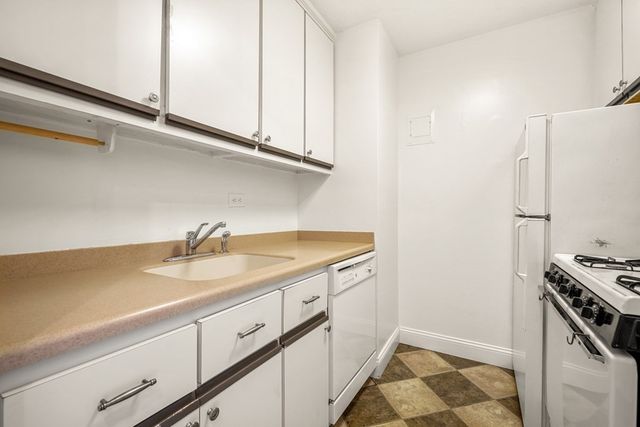 a kitchen with stainless steel appliances granite countertop a sink and a stove