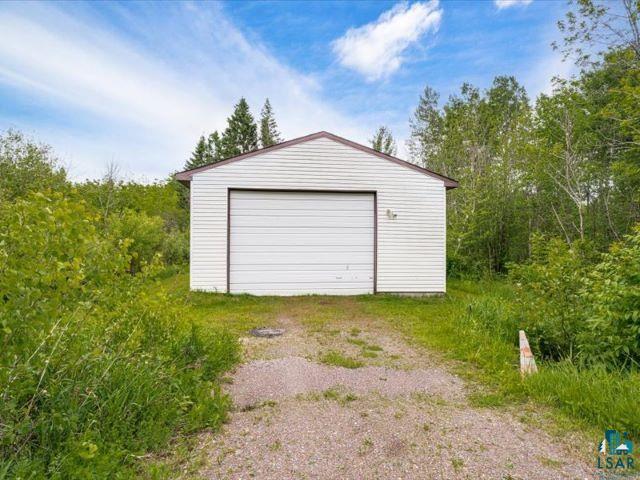 3616 Lavaque Road Hermantown, MN 55811 - Photo 19 of 43 Detached garage with white horizontal siding and a single overhead door