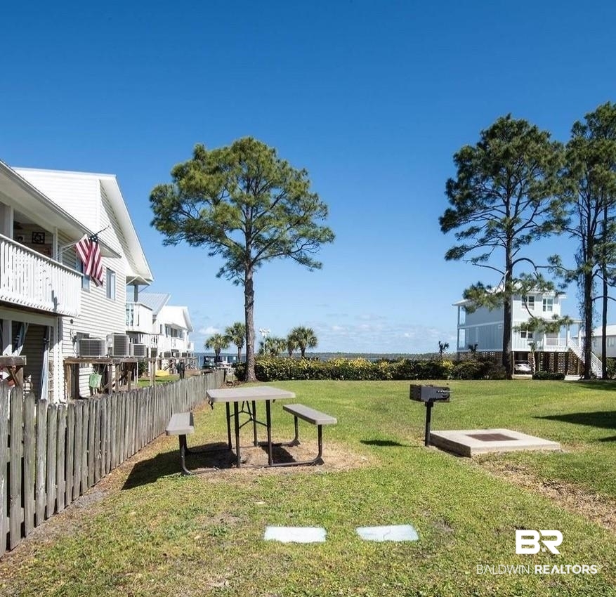 25957 Canal Road, Unit 206 Orange Beach, AL 36561 - Photo 25 of 30 View of property's community with a yard, a residential view, and fence