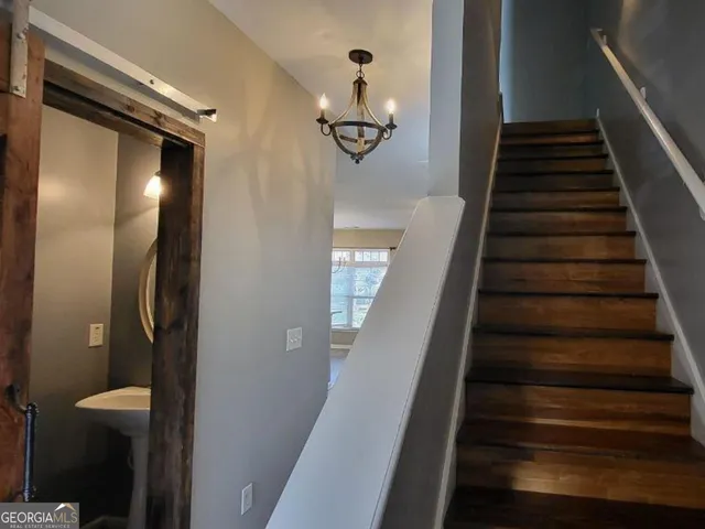 a view of entryway and hall with wooden floor