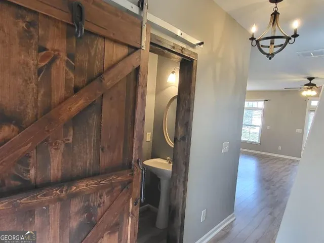a view of a hallway with wooden floor and staircase