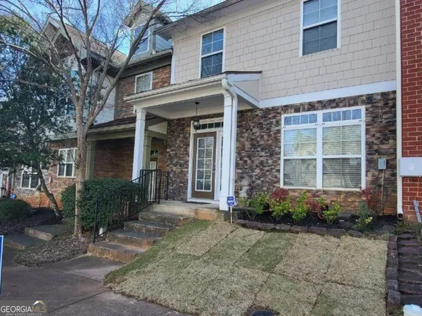 a front view of a house with garden