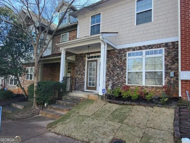 a front view of a house with garden