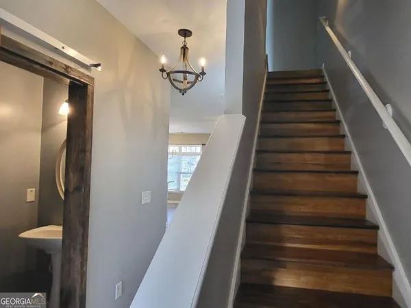 a view of entryway and hall with wooden floor