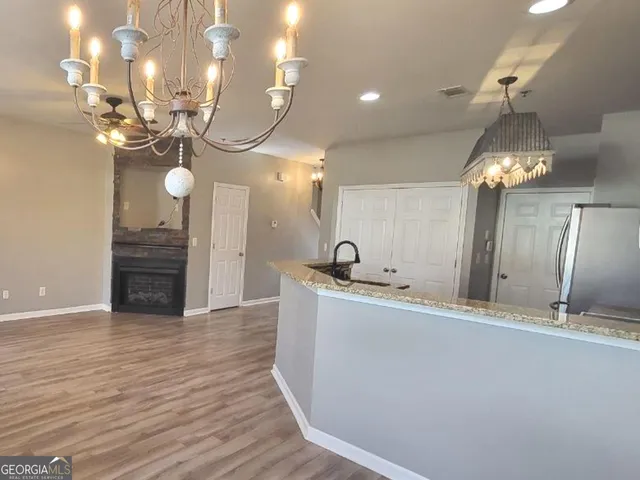 a view of a kitchen with a sink and chandelier