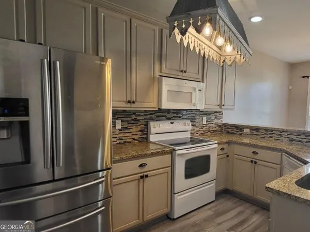 a kitchen with cabinets stainless steel appliances and a counter space