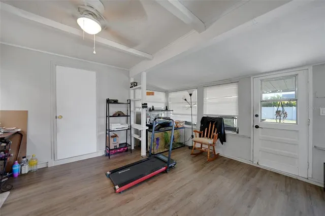 a view of a room with gym equipment and a window