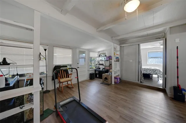 a view of a room with furniture and wooden floor