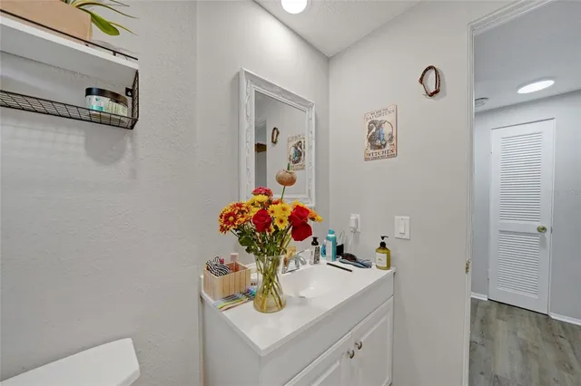 a bathroom with a sink vanity and mirror
