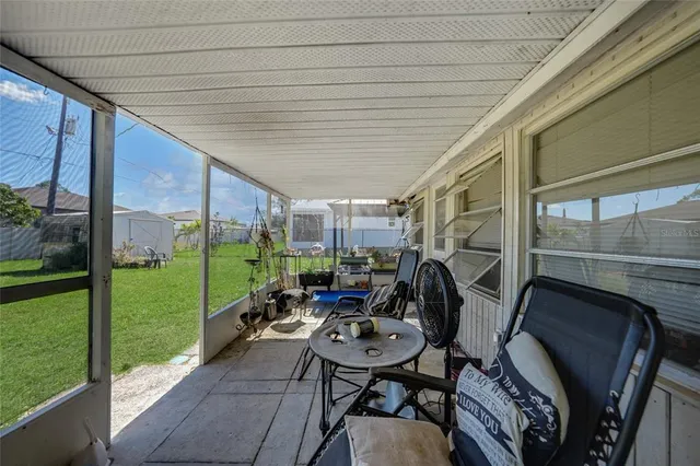 a view of yard from deck with patio