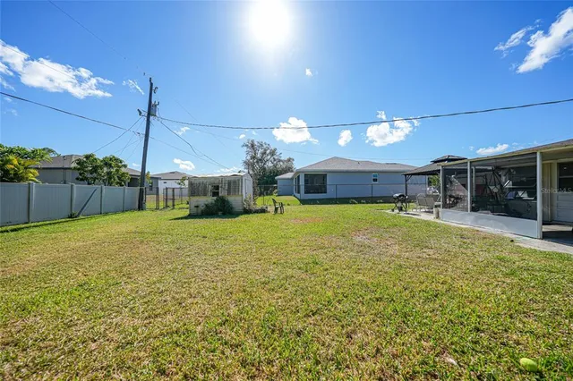 a view of a house with a backyard and a area