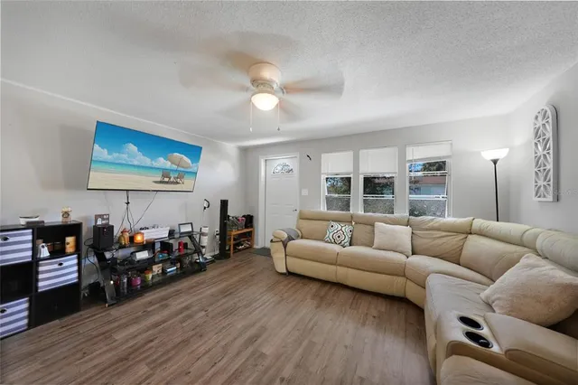 a living room with furniture and wooden floor