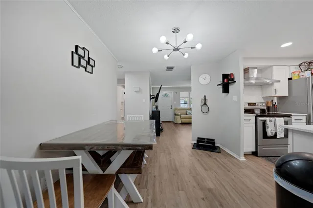 a view of a workspace with furniture and wooden floor