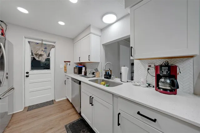a kitchen with a sink and cabinets