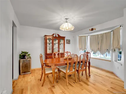 a view of a dining room with furniture window and wooden floor