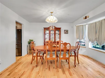 a view of a dining room with furniture window and wooden floor