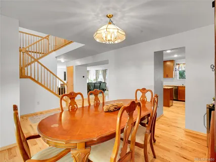 a dining room with furniture and a chandelier